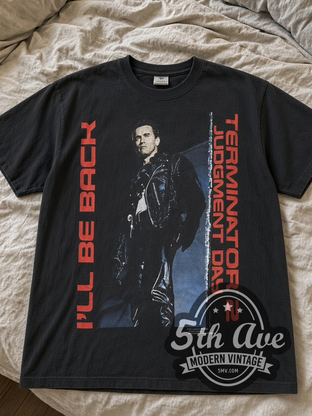 Black Terminator 2: Judgment Day I'll Be Back & T2 Motorcycle tee laid flat on linen bed