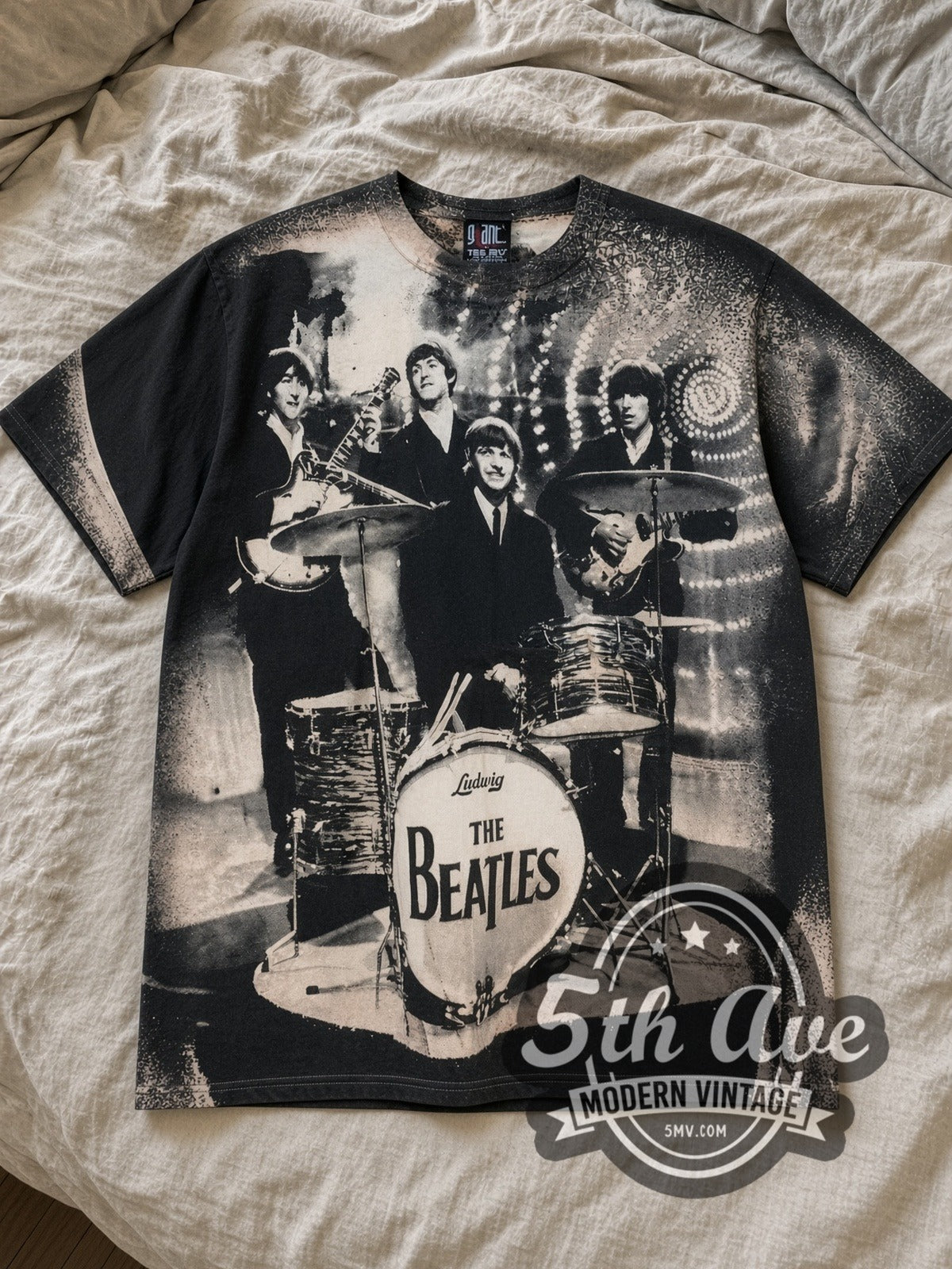 Black The Beatles Live Stage Ludwig Drum Black All Over Print Vintage Band T-Shirt laid flat on a linen bed