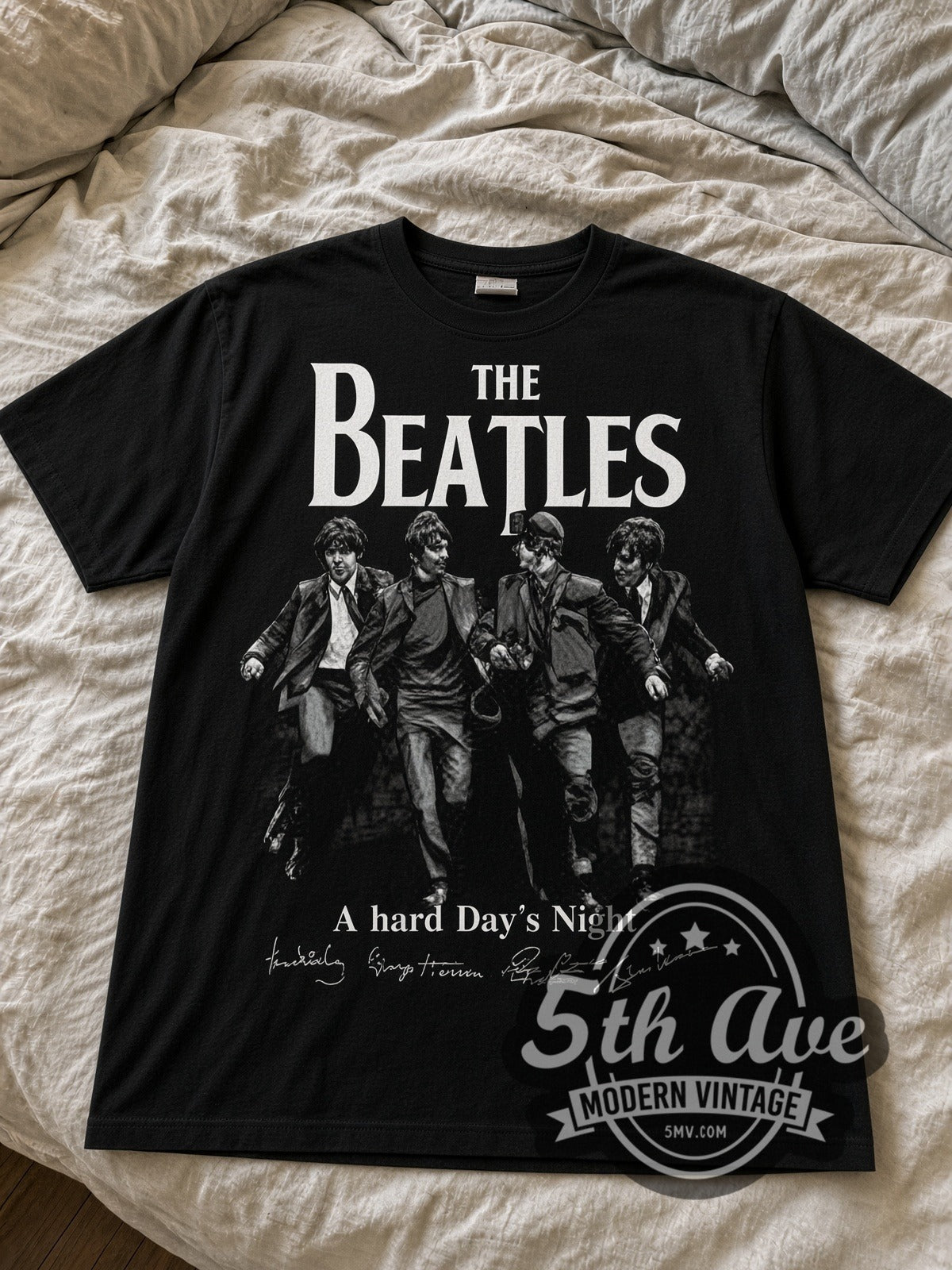 The Beatles A Hard Day's Night Walking black graphic tee laid flat on linen bed