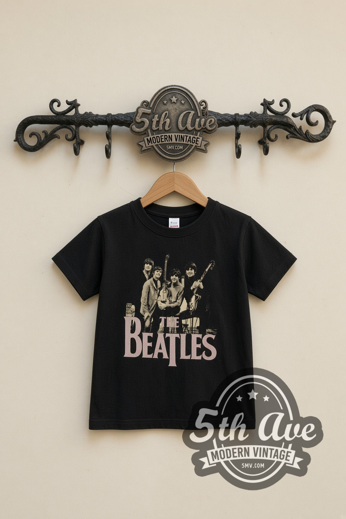 The Beatles Band Photo Logo kids band tee in black, front view on a display rack