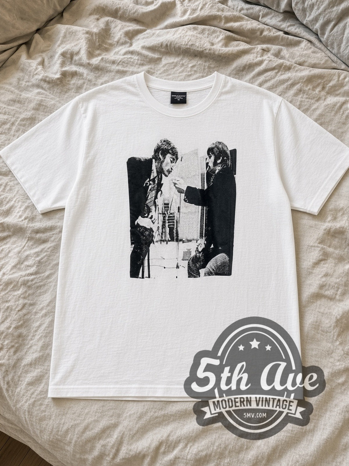 White The Beatles Cigarettes Vintage Band T-Shirt laid flat on a linen bed