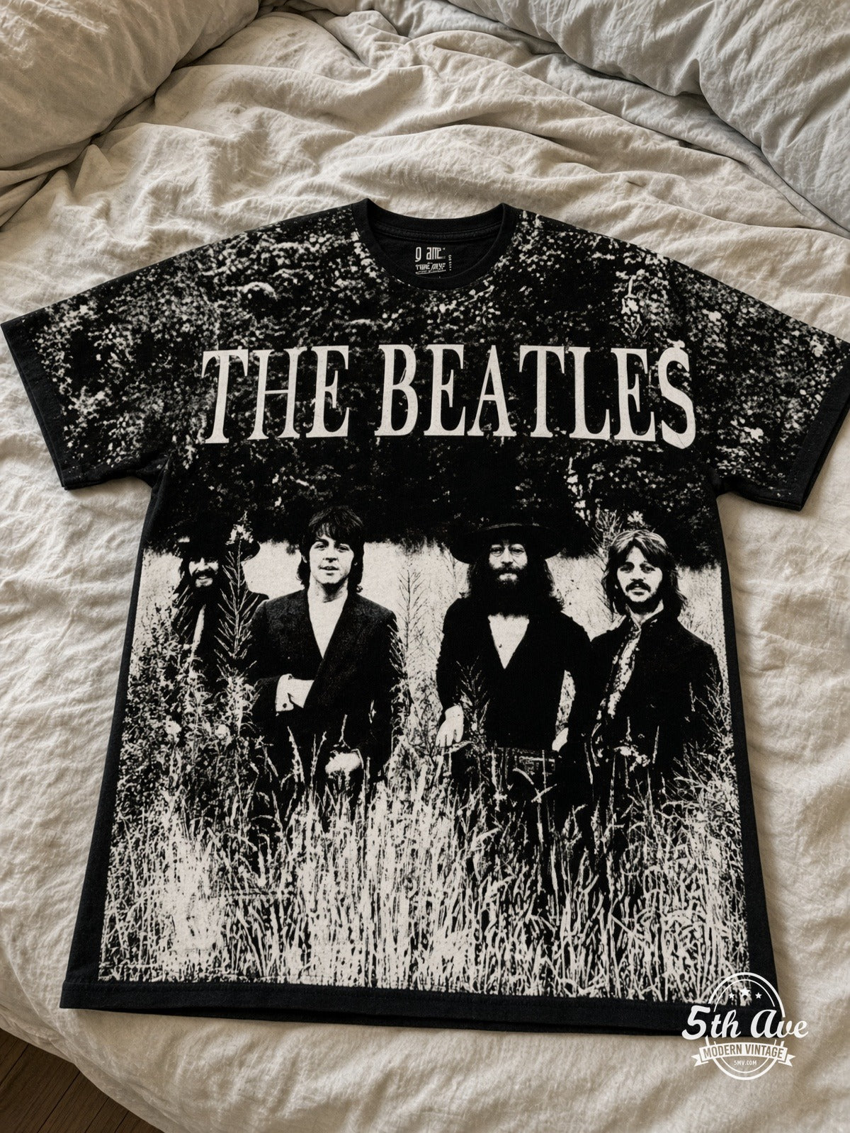 The Beatles Field Photo all over print vintage tee laid on bed