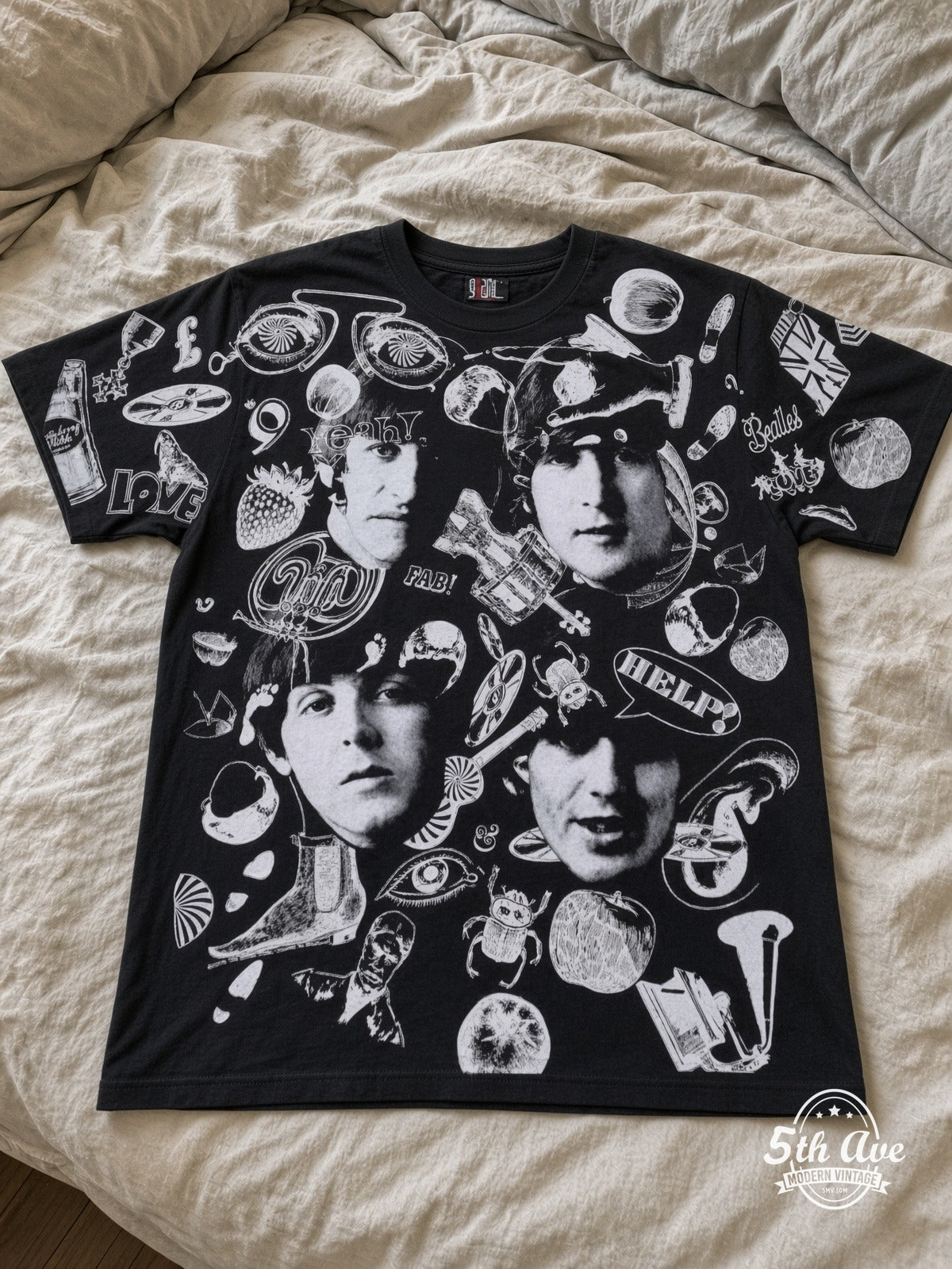 The Beatles Help Collage all over print vintage tee laid on bed