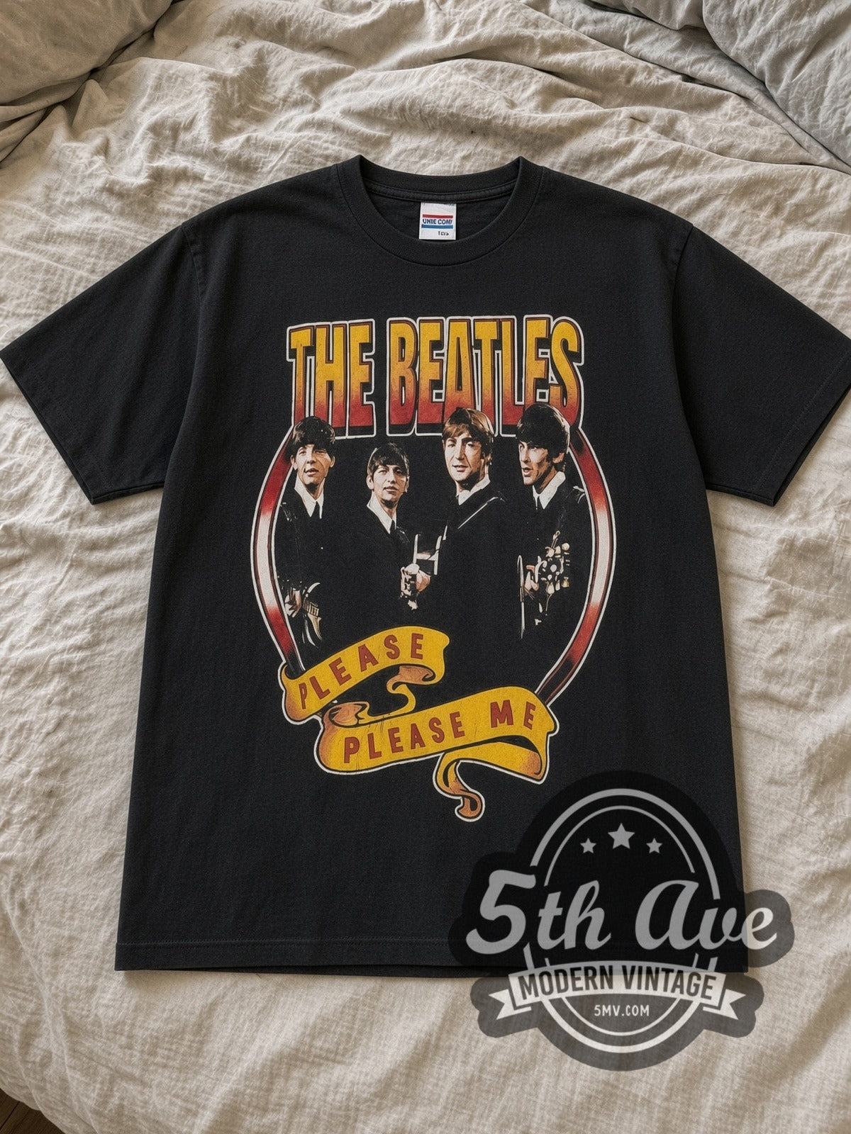 Black The Beatles Please Please Me 1963 Vintage Band T-Shirt laid flat on a linen bed