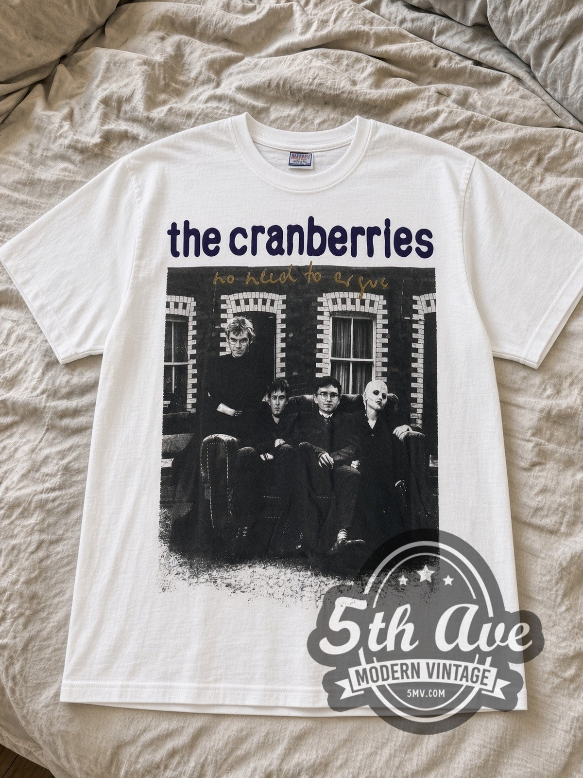 White Cranberries No Need to Argue tee laid flat on linen bed