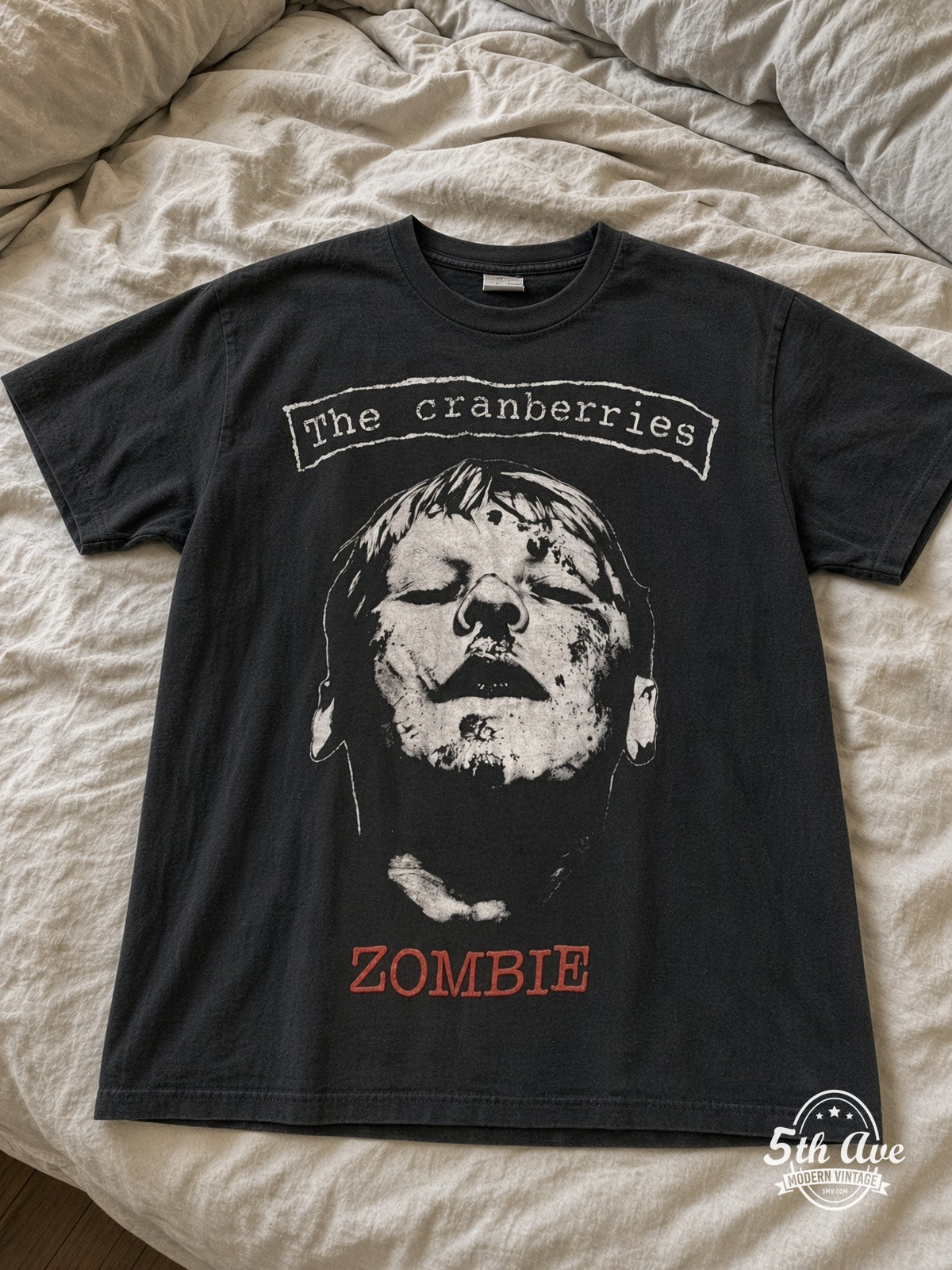 The Cranberries Zombie No Need to Argue vintage tee laid on bed