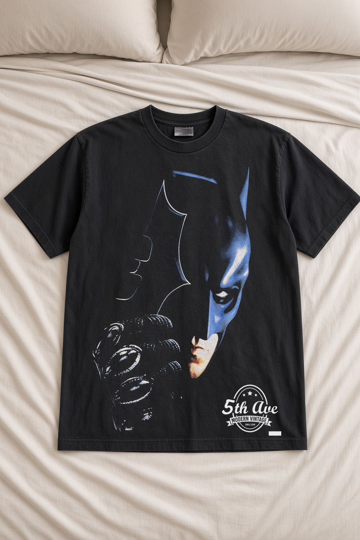 The Dark Knight Batman Tumbler vintage t-shirt laid on bed