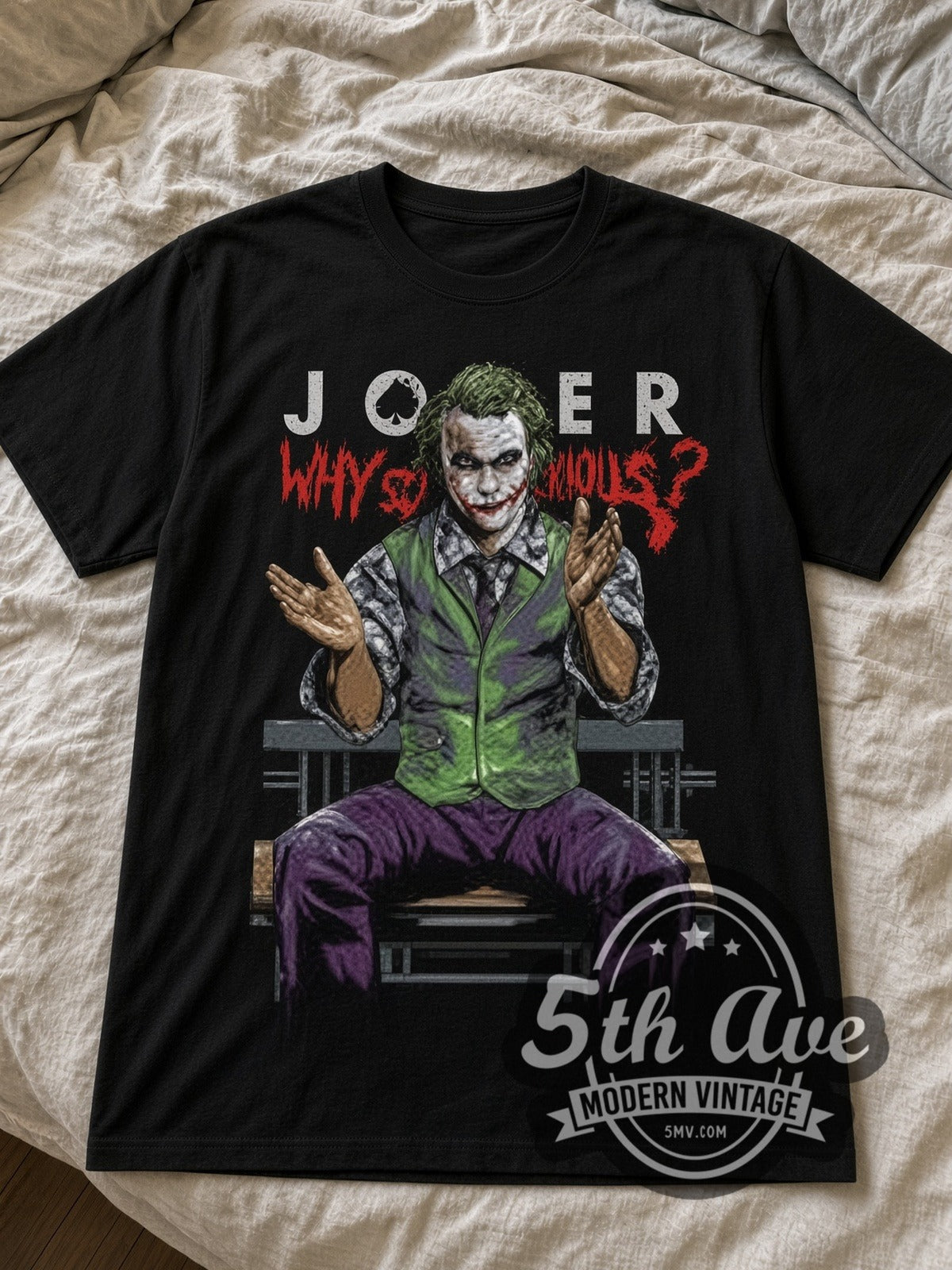 Joker Why So Serious Dark Knight black graphic tee laid flat on linen bed