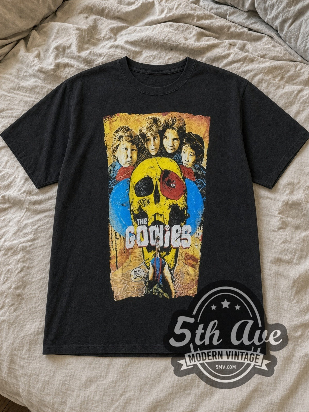 Black The Goonies Vintage Movie T-Shirt laid flat on a linen bed