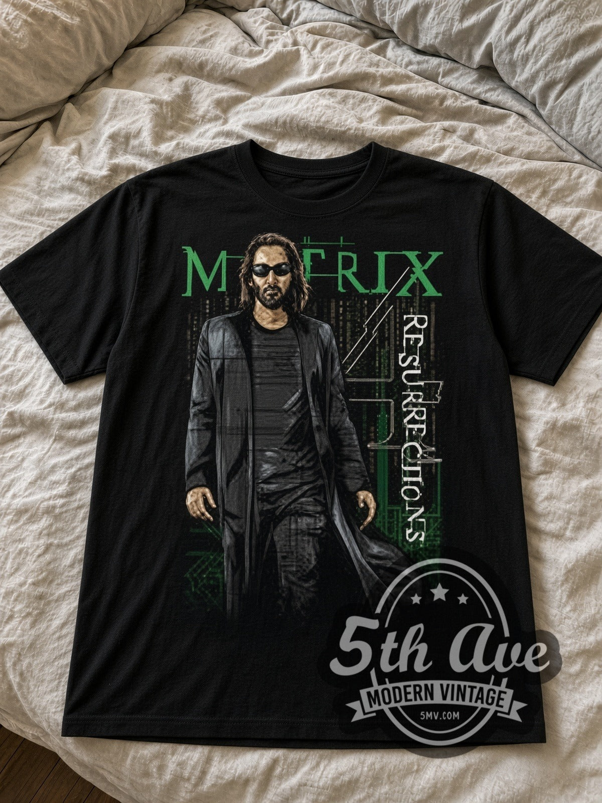 The Matrix Resurrections Neo black graphic tee laid flat on linen bed
