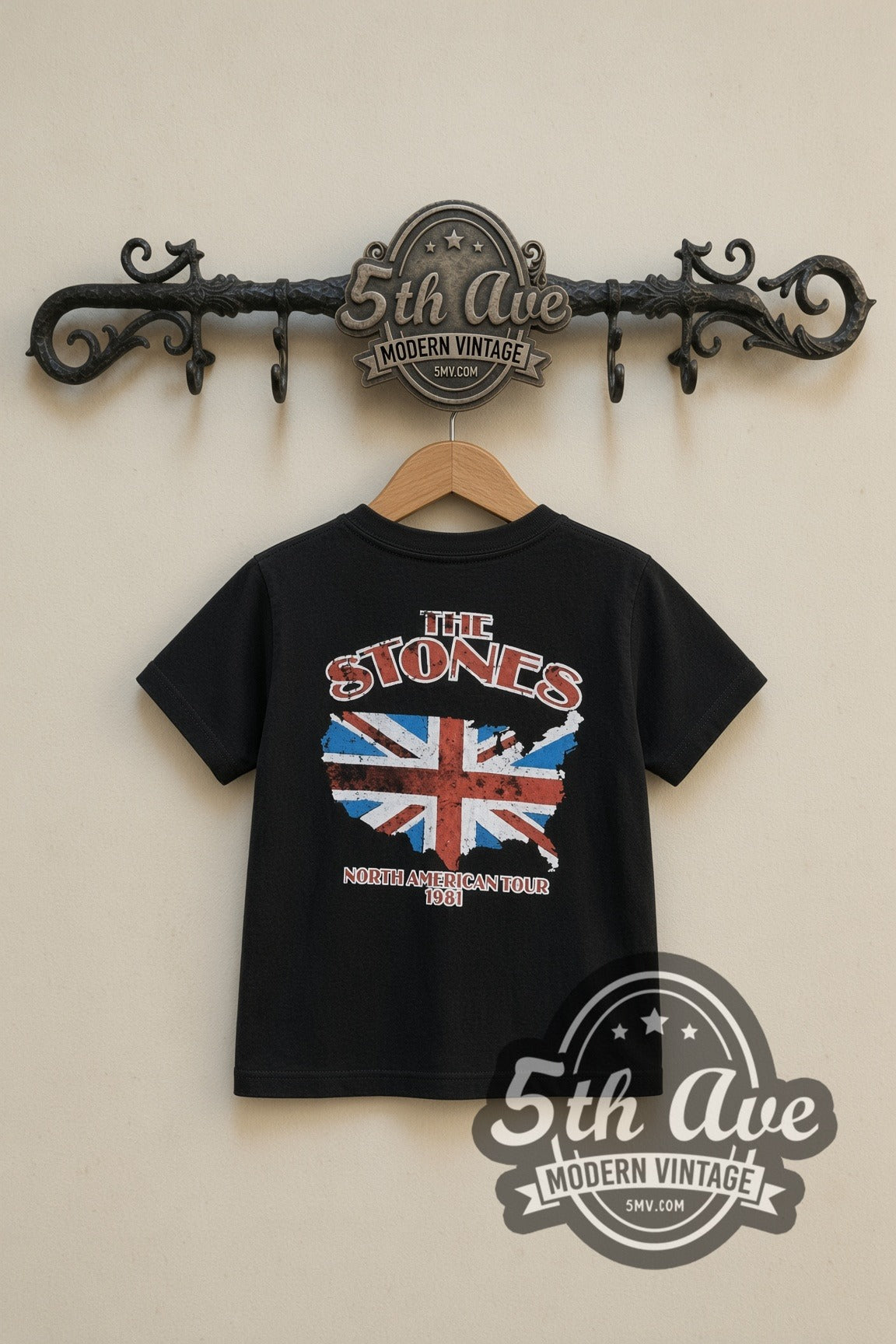 The Rolling Stones American Flag Tongue kids band tee in black, back view on a display rack