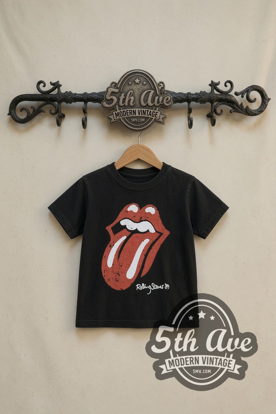 The Rolling Stones Classic Tongue kids band tee in black, front view on a display rack