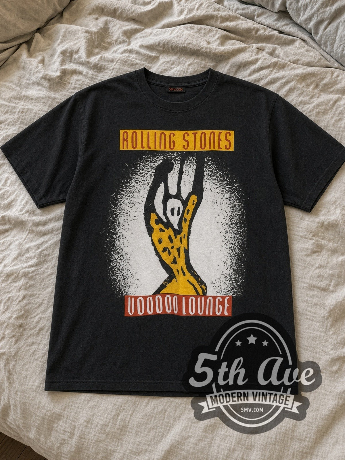 Black The Rolling Stones Voodoo Lounge European Tour 1995 Vintage Band T-Shirt laid flat on a linen bed