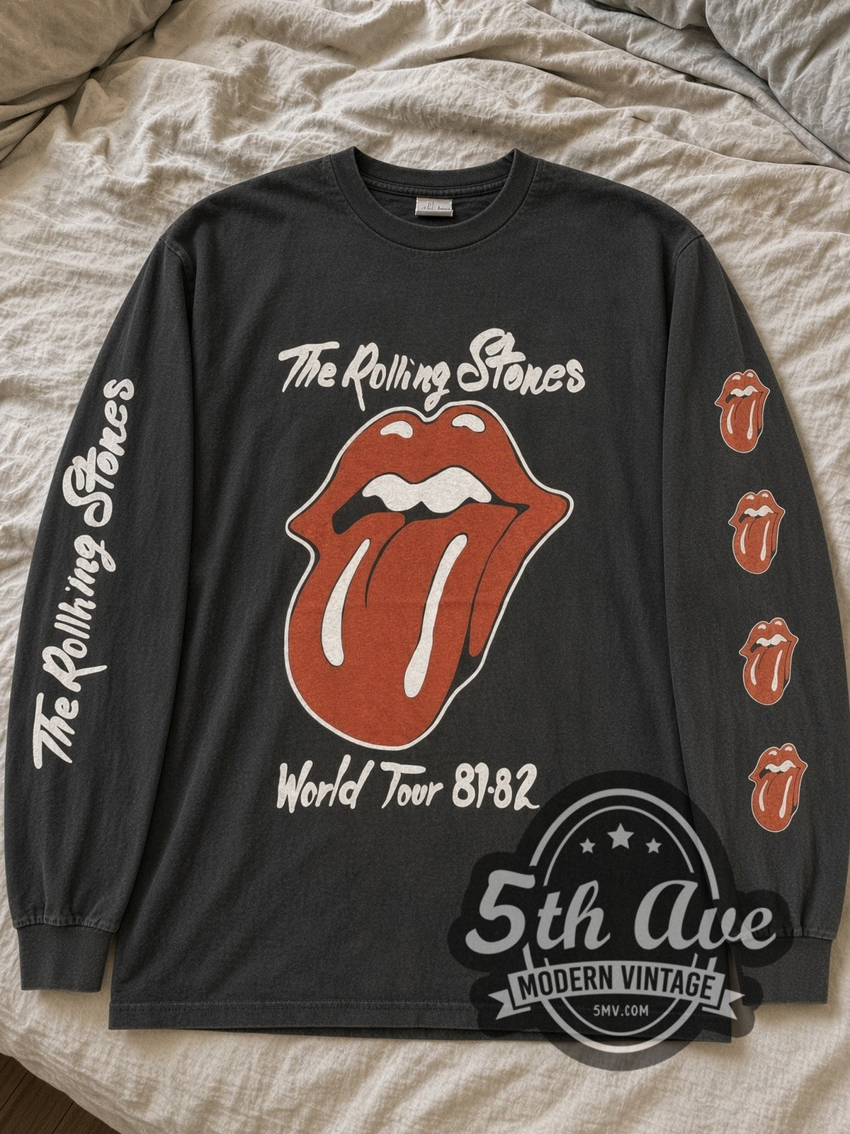 Faded black The Rolling Stones World Tour 81-82 Tongue & Globe long sleeve tee laid flat on linen bed