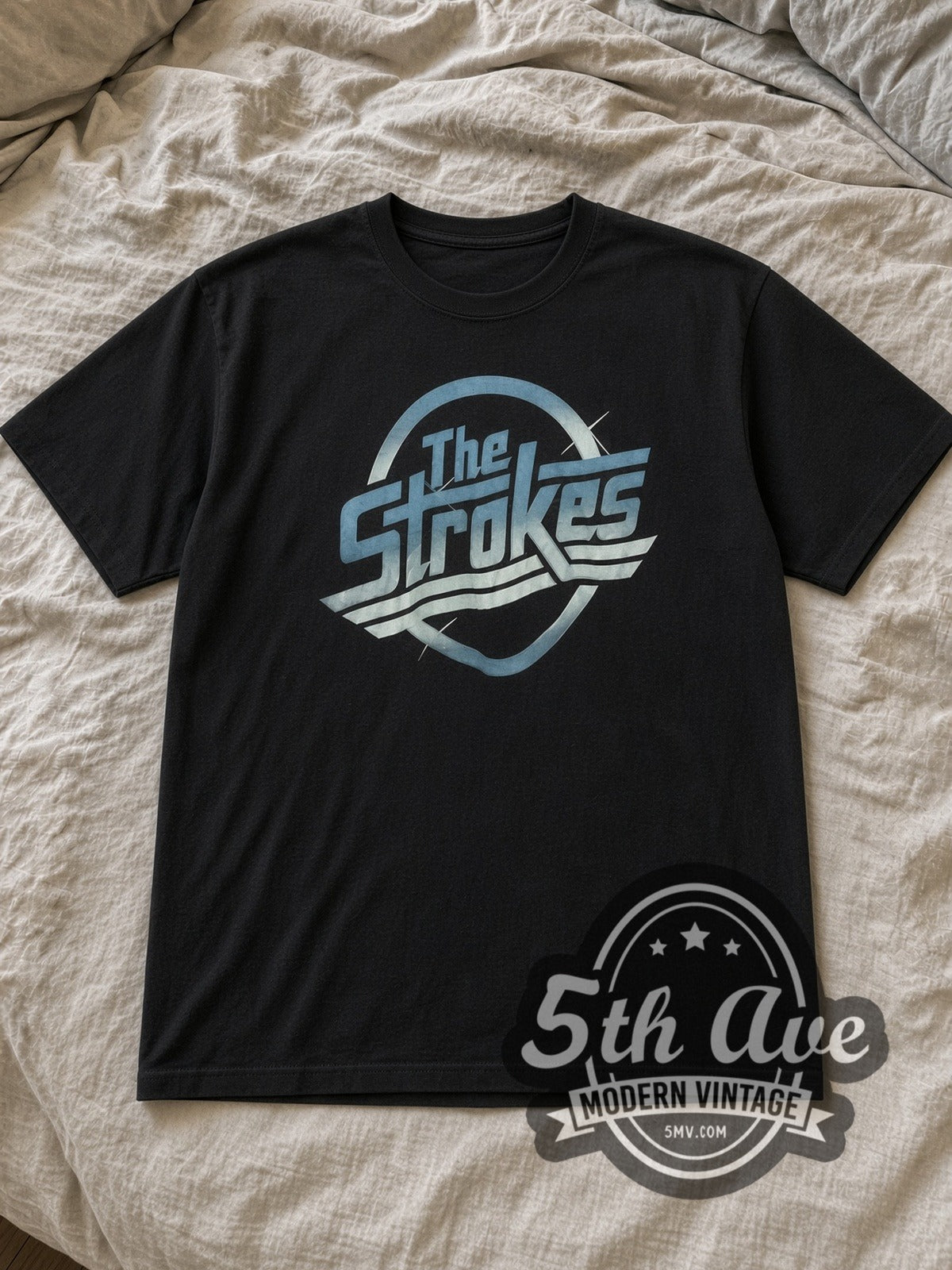 Black The Strokes Vintage Band T-Shirt laid flat on a linen bed