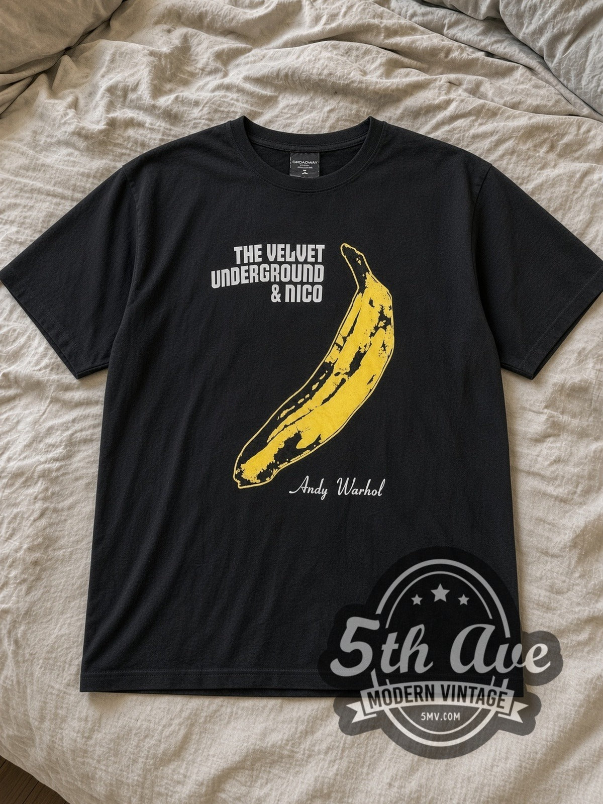Black The Velvet Underground Vintage Band T-Shirt laid flat on a linen bed