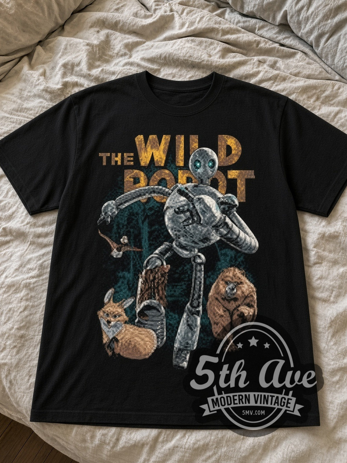 The Wild Robot Roz black graphic tee laid flat on linen bed