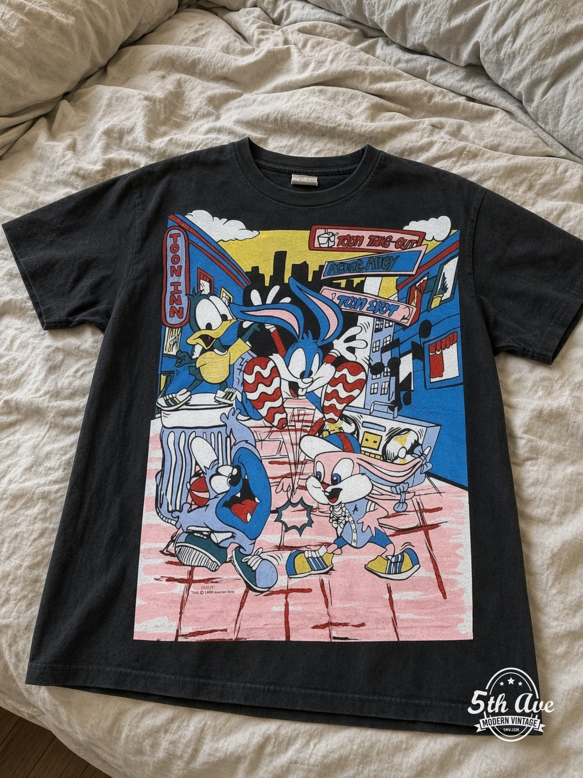 Tiny Toon Adventures Toon Town Crew vintage tee laid on bed