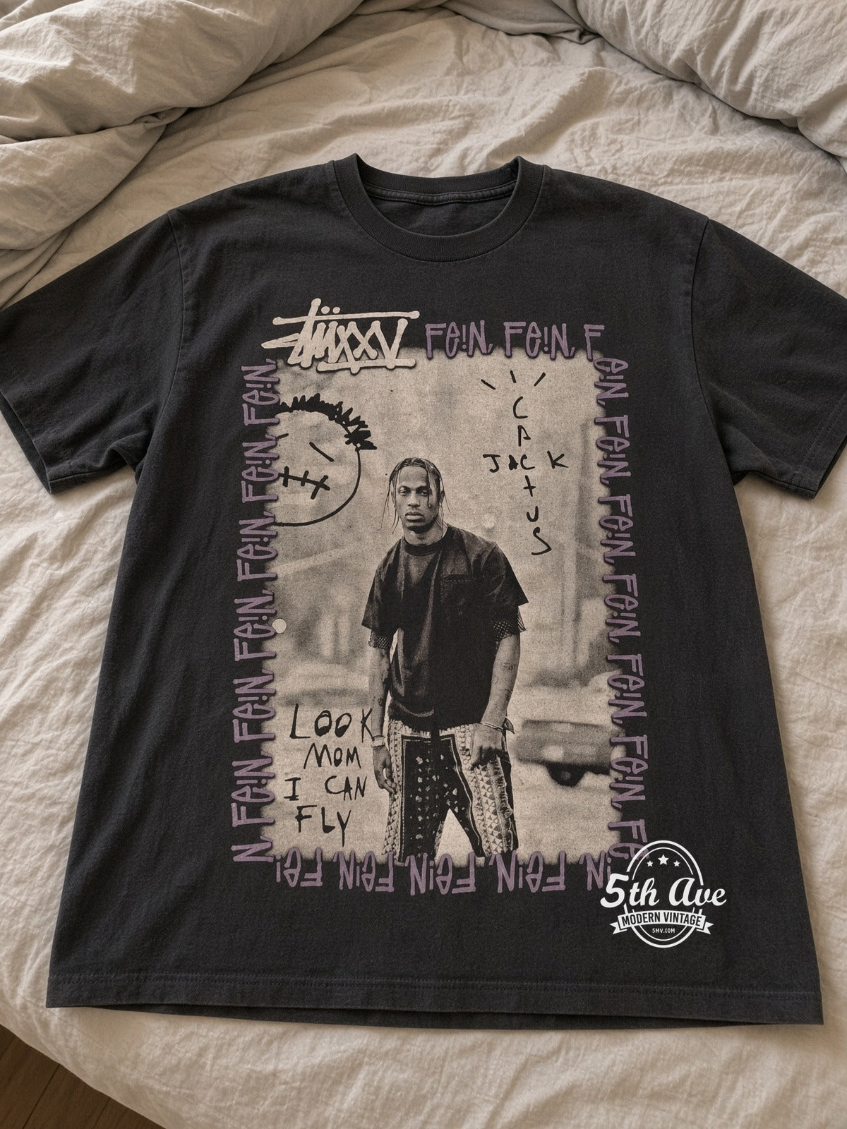 Travis Scott Stüssy FEIN Cactus Jack vintage band tee laid on bed