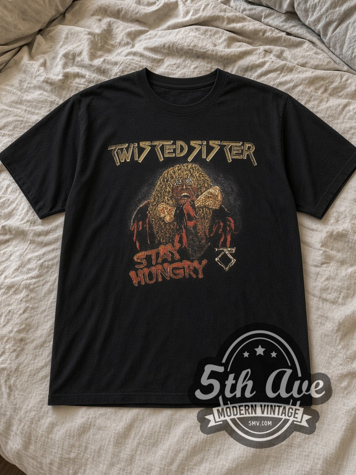 Black Twisted Sister Stay Hungry Dee Snider Biting Bone Vintage Band T-Shirt laid flat on a linen bed