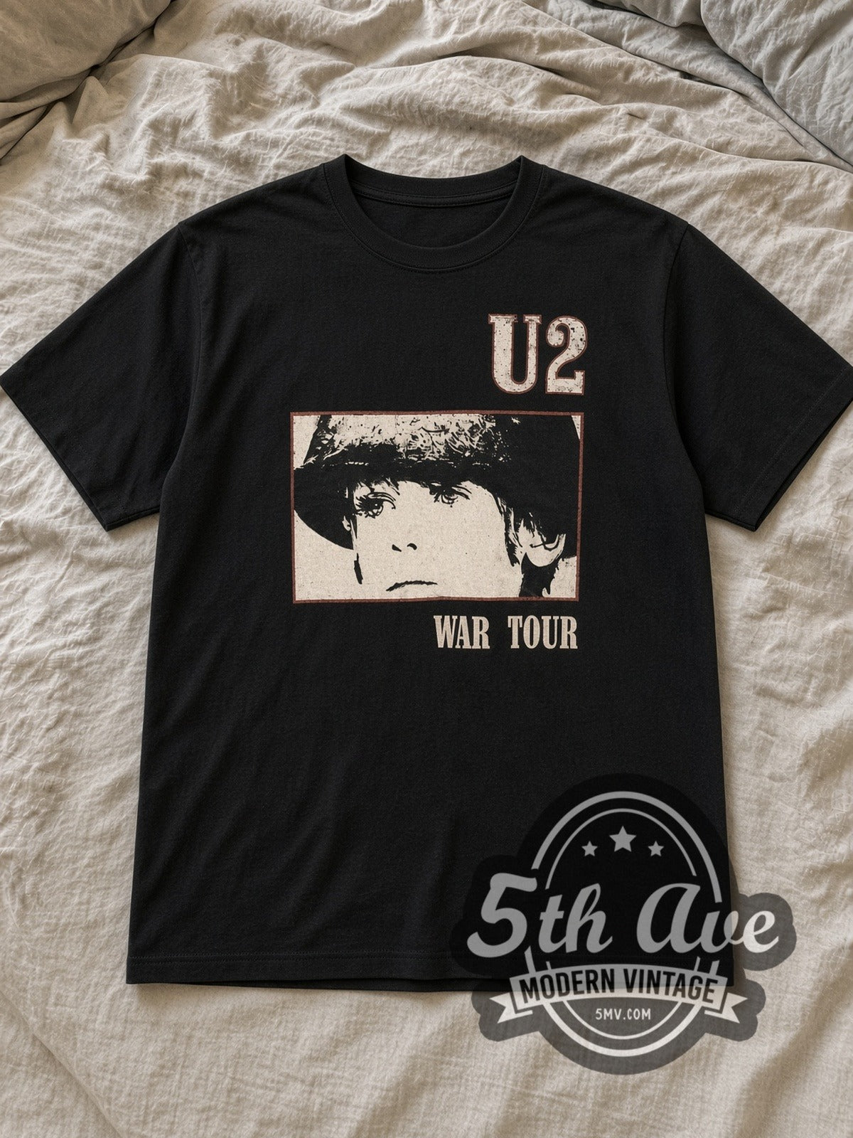 Black U2 Vintage Band T-Shirt laid flat on a linen bed