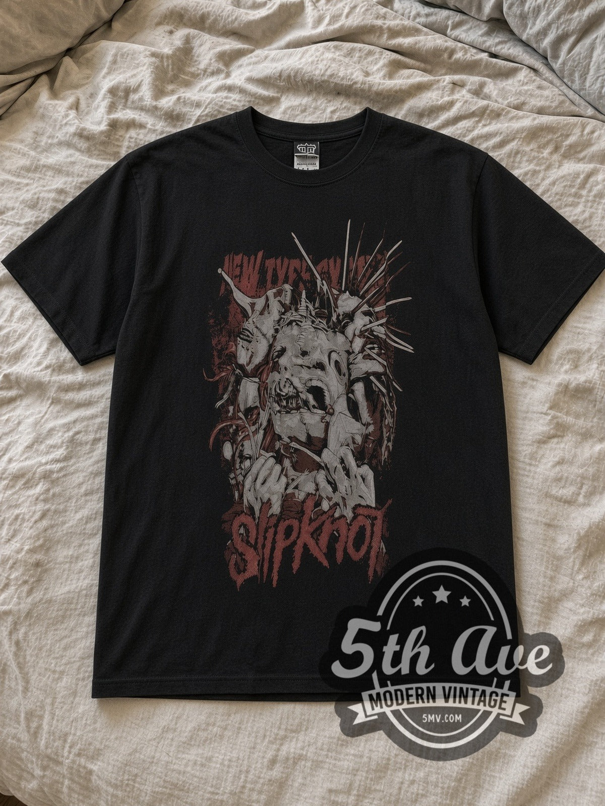 Black Slipknot Unleash the Madness Vintage Band T-Shirt laid flat on a linen bed