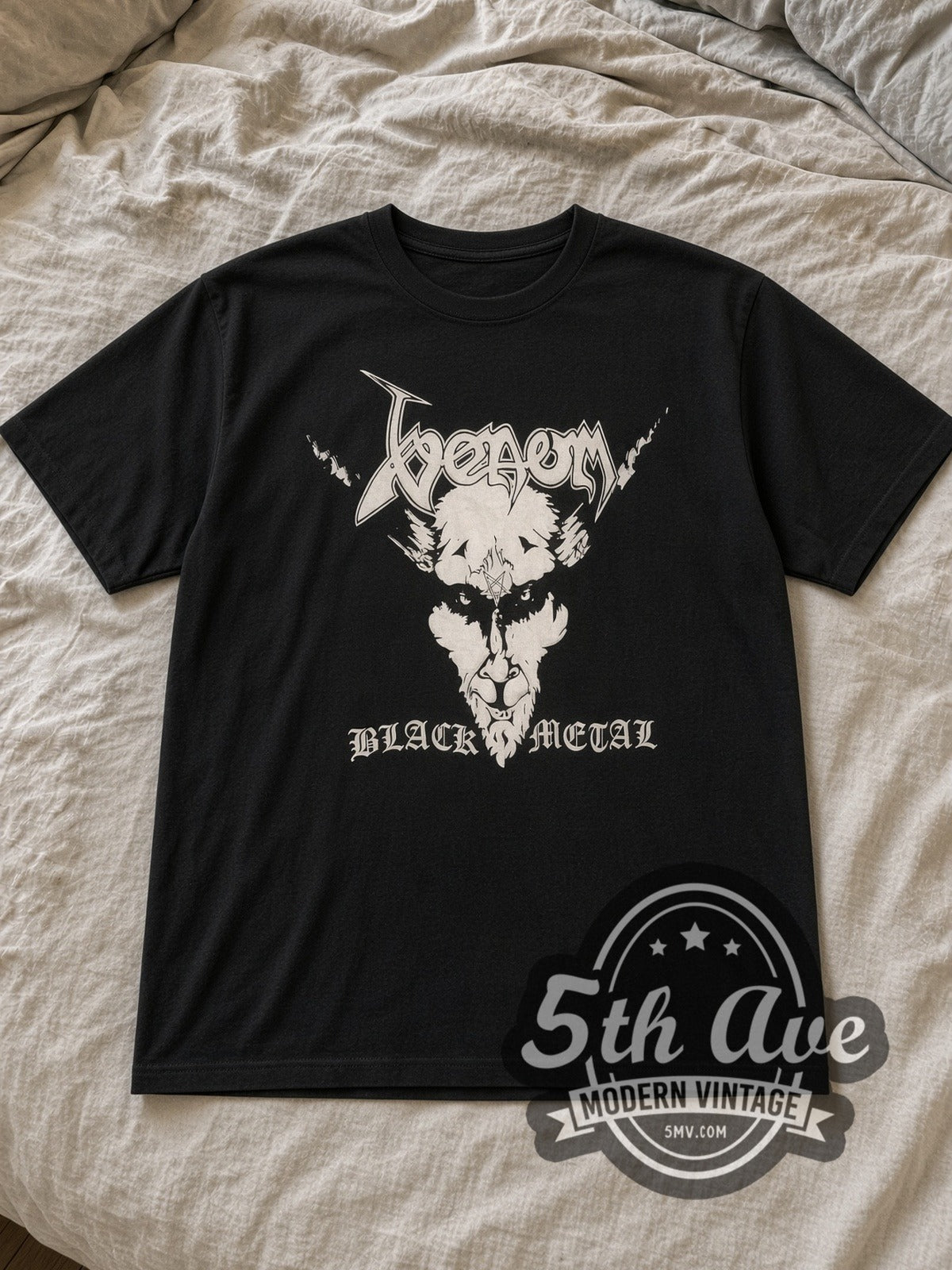 Black Venom Vintage Band T-Shirt laid flat on a linen bed