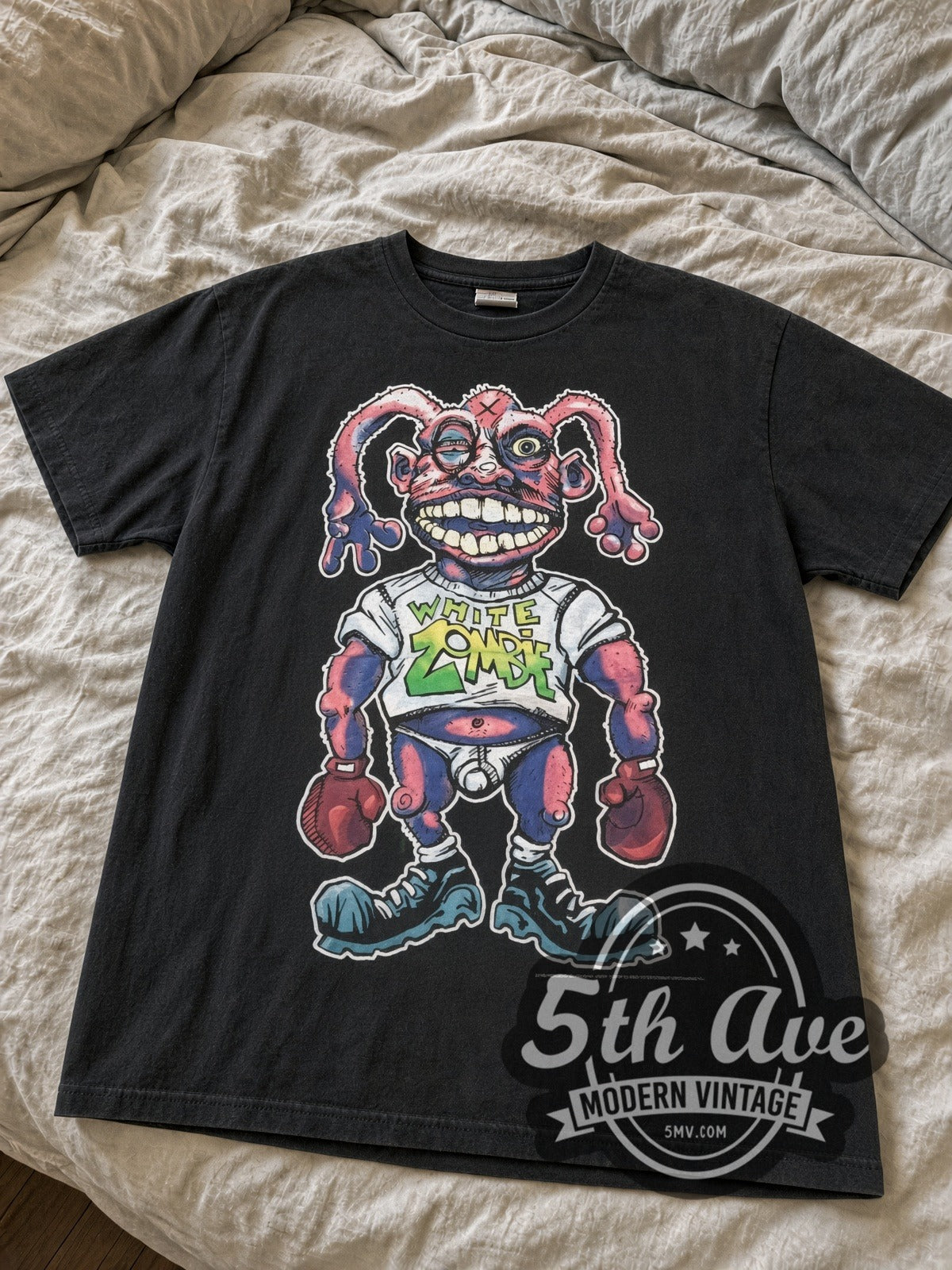 Faded black White Zombie boxer More Human Than Human tee laid flat on bed