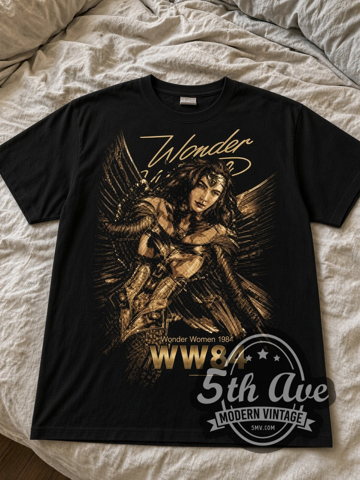 Wonder Woman 1984 Golden Armor black graphic tee laid flat on linen bed