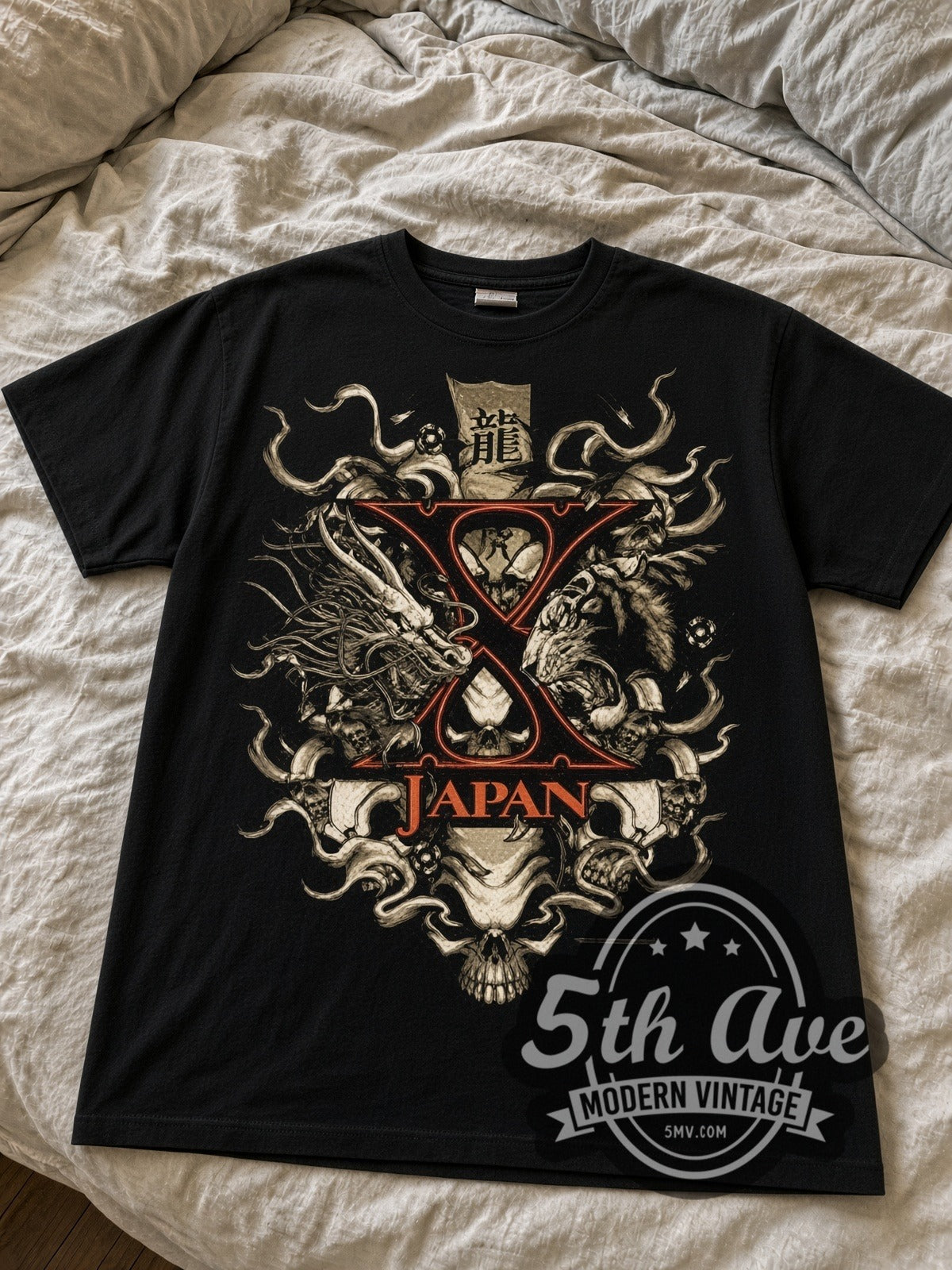 X Japan Dragon Crest with X Logo black graphic tee laid flat on linen bed